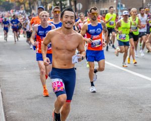 Happy man running in 2023 TCS NYC Marathon. Shirtless fitness Runners professional Photography. #2934 Corral A