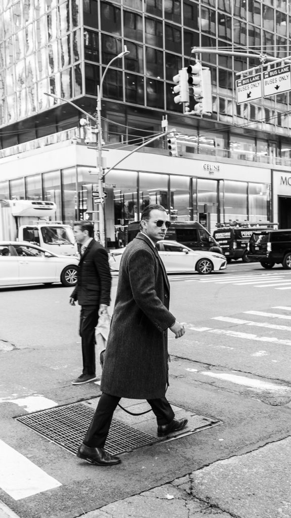 Fine photography of a business man crossing the street in Manhattan