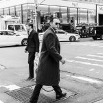 Fine photography of a business man crossing the street in Manhattan