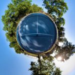 insta360 one x2 NYC photography by VIK, tiny planet photograph of a park and bright blue skies and green trees.