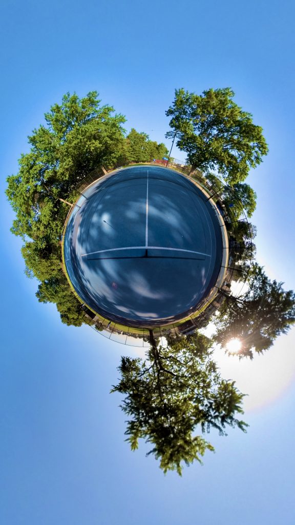 insta360 one x2 NYC photography by VIK, tiny planet photograph of a park and bright blue skies and green trees.