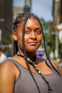 Portrait of a young woman on the street in Cleveland Ohio sidewalk on a sunny day.