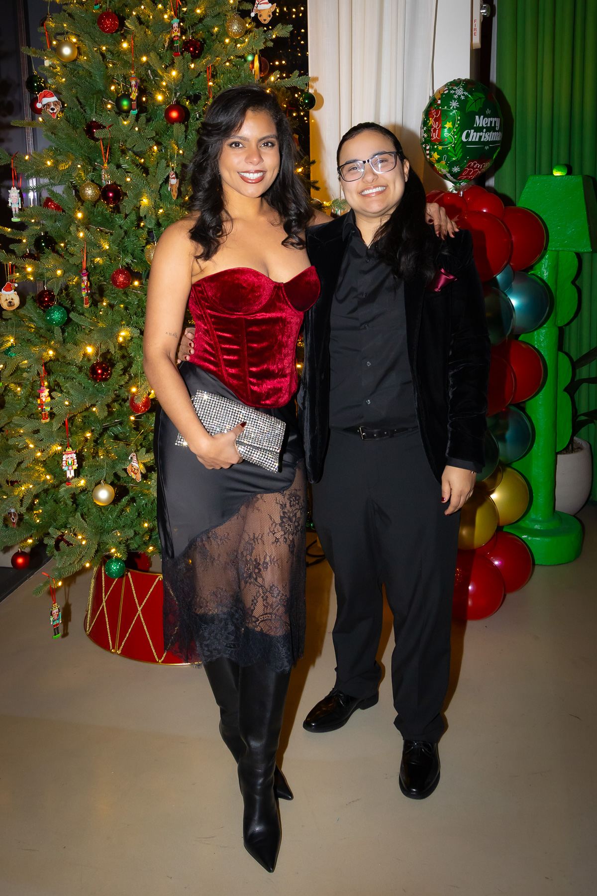 Stylish guests posing for a glamorous group photo at a luxury holiday party.