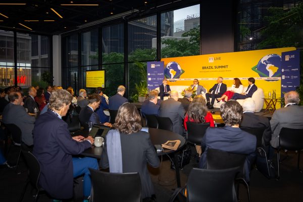 panel of experts discussing trends during a corporate summit in NYC.