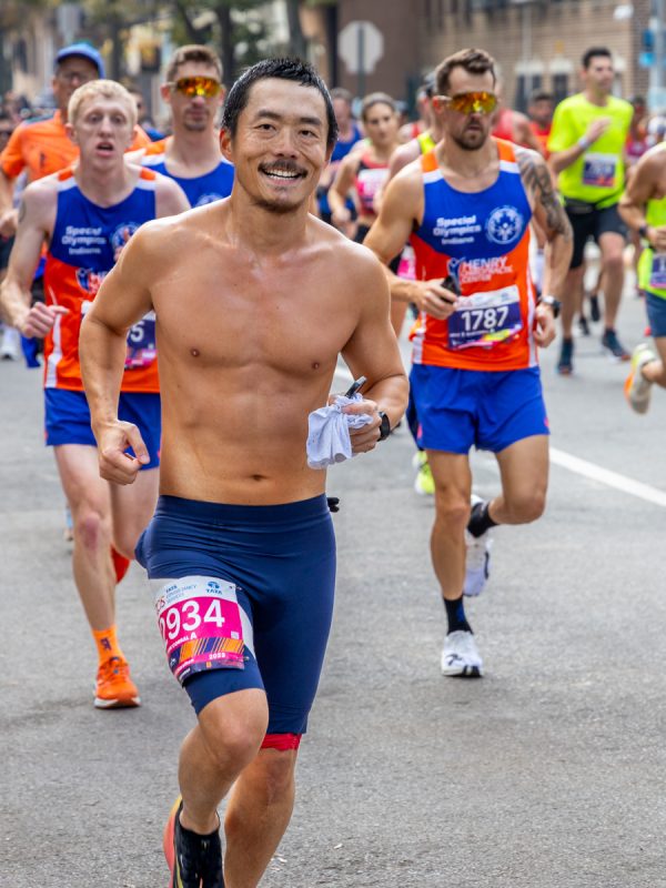 Happy man running in 2023 TCS NYC Marathon. Shirtless fitness Runners professional Photography. #2934 Corral A