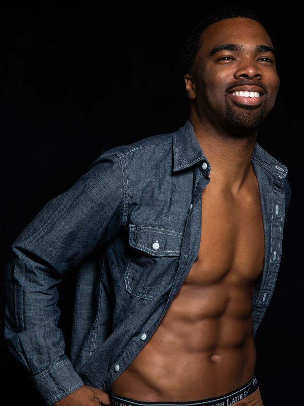 Sexy black man with shirt off studio portrait fashion photoshoot